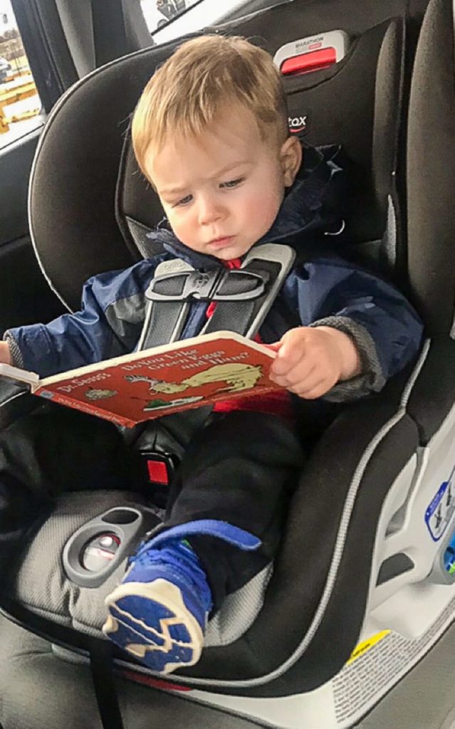 Child reading in the car